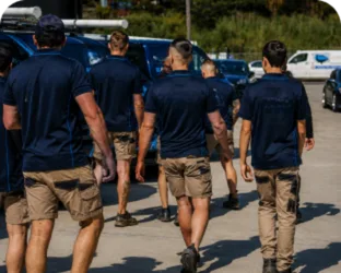 Plumbers walking to their service vans on a Beaumont Hills job